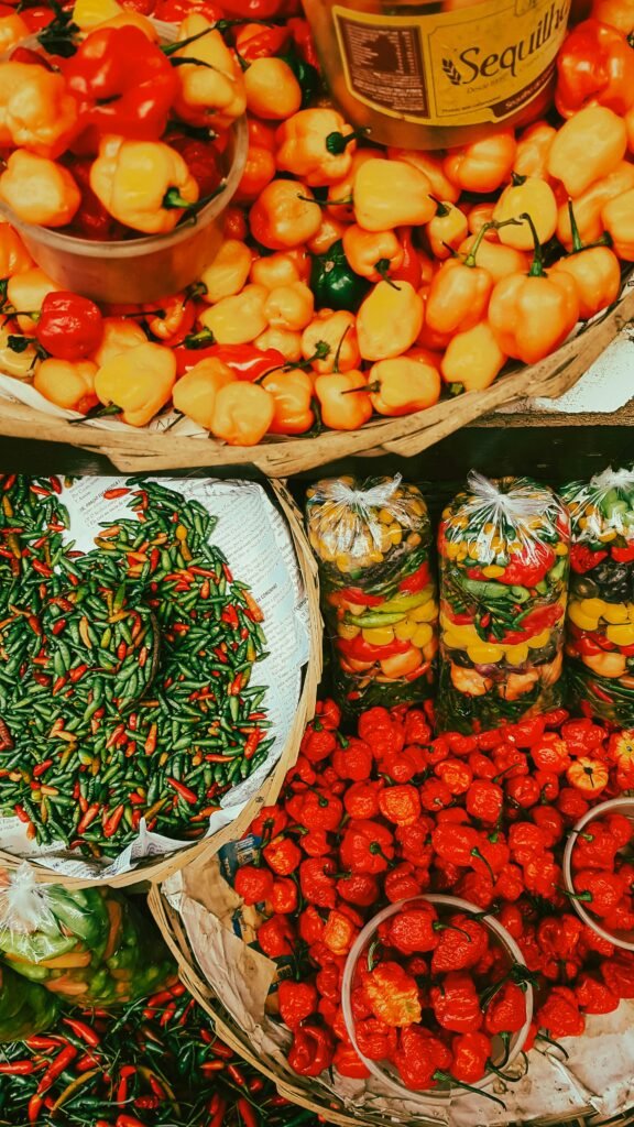 Vibrant assortment of peppers on display at a Salvador market, showcasing local produce.