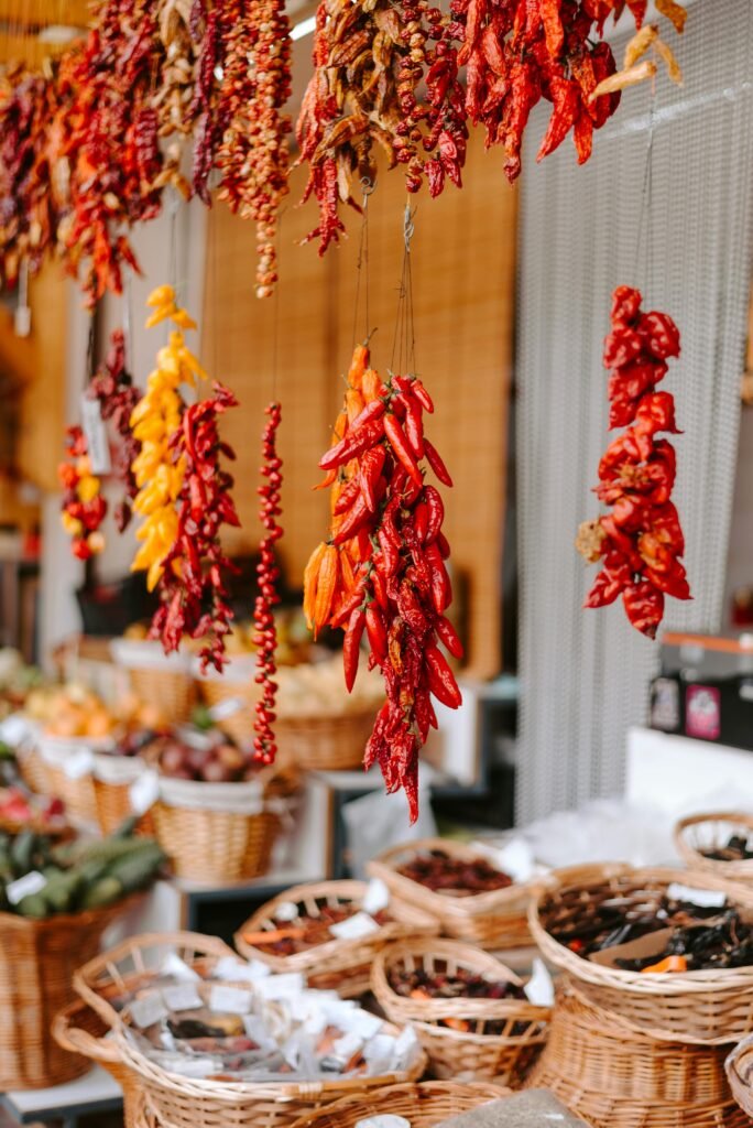 Colorful dried peppers hanging in a Madeira marketplace.